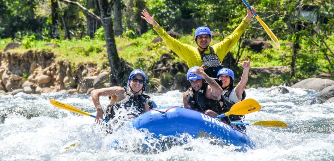 Rafting guide and group navigating a river section near Arenal