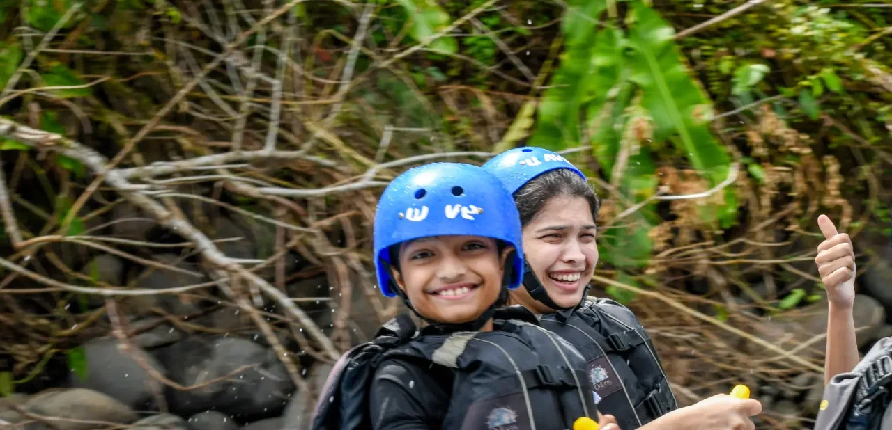 smiling kids enjoying a family rafting tour with wave expeditions in costa rica