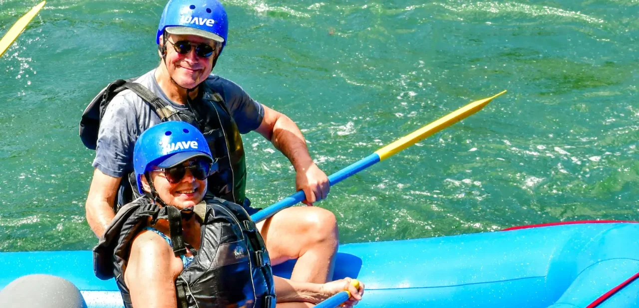father and daughter enjoying a calm rafting section with wave expeditions in costa rica